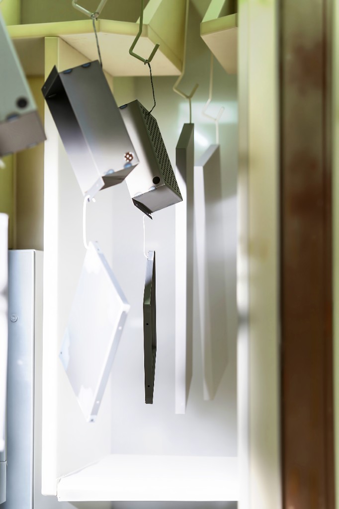 Powder-coated electrical parts in a finishing line